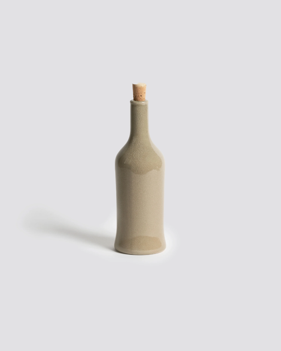 Decorative bottle with a cork stopper on a light gray background